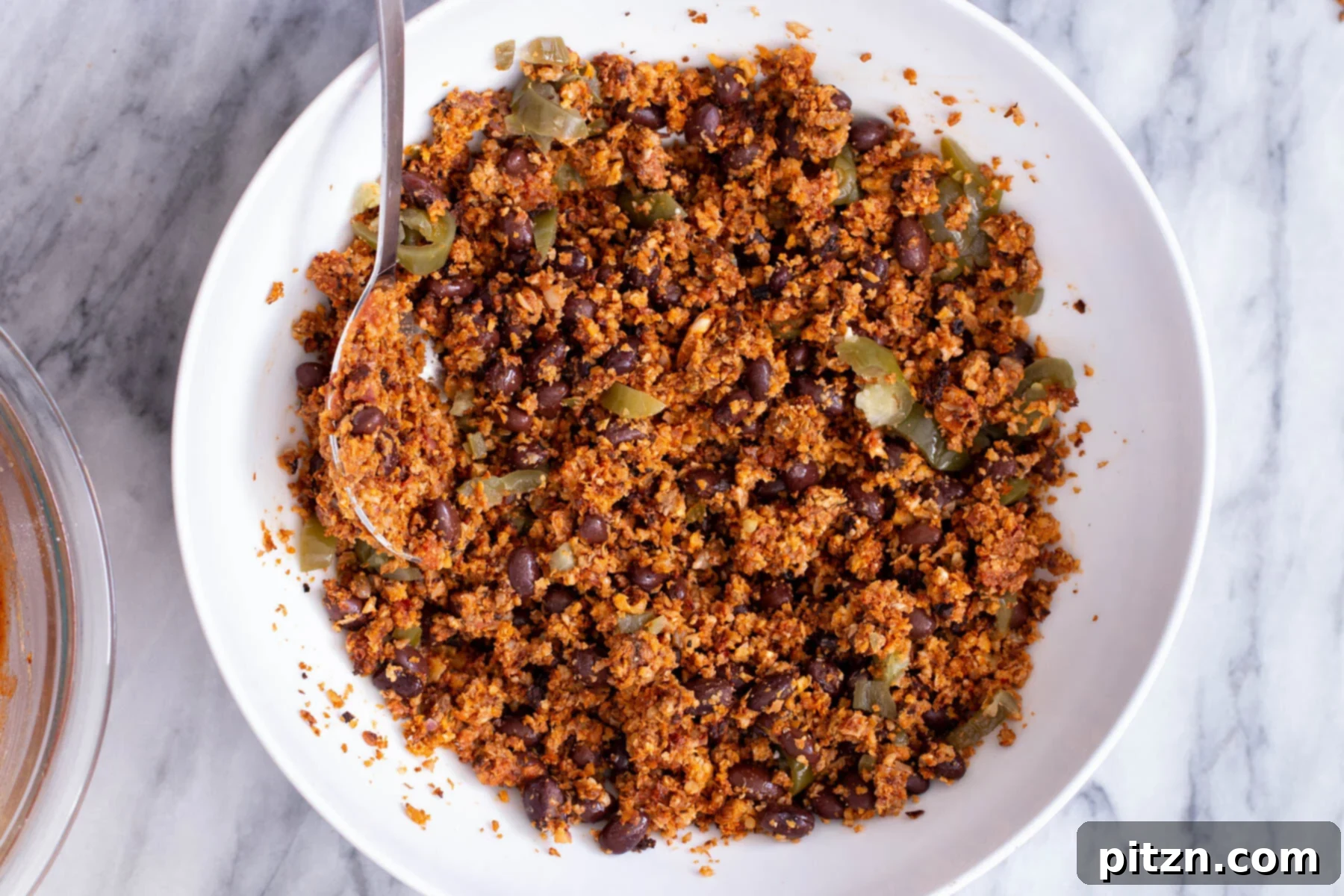 Black beans and green chilies thoroughly mixed into the cauliflower taco meat, creating a rich and textured enchilada filling.