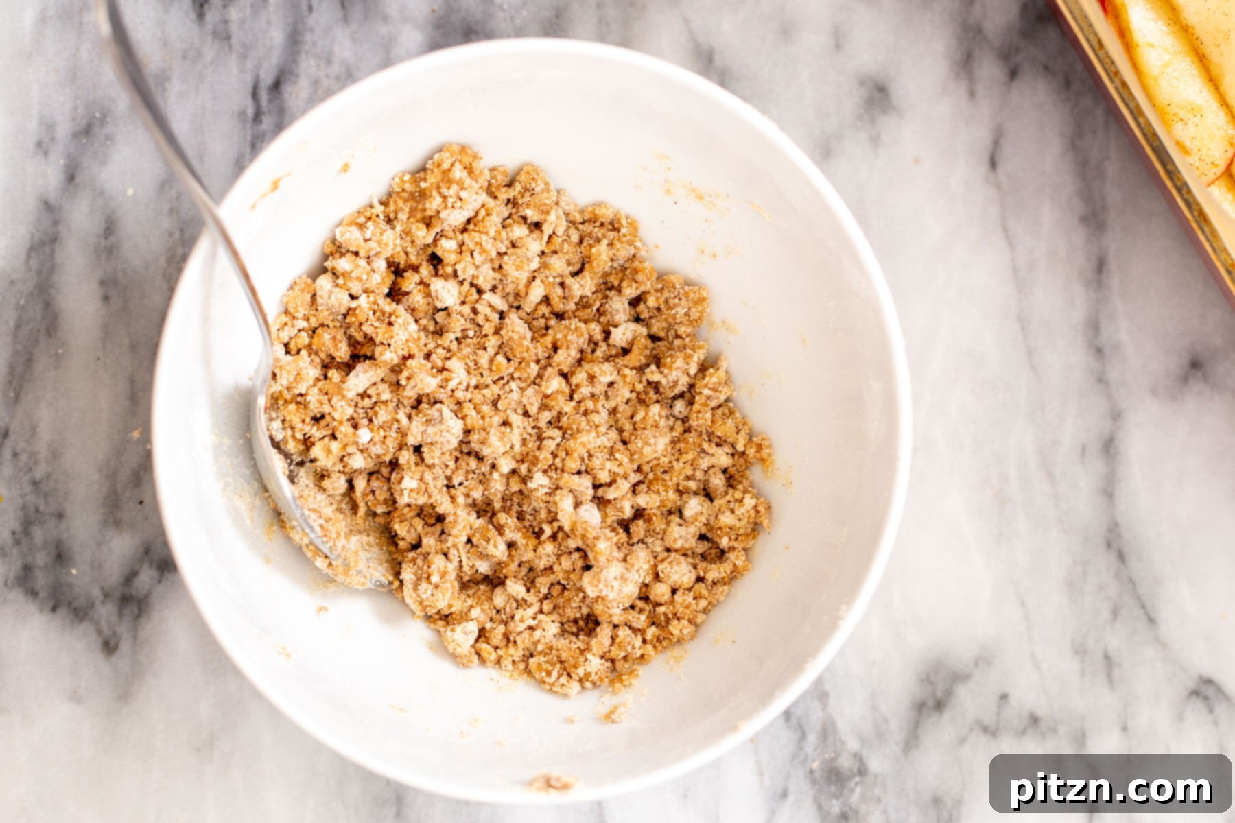 crumble topping for apple pie bars in a white bowl