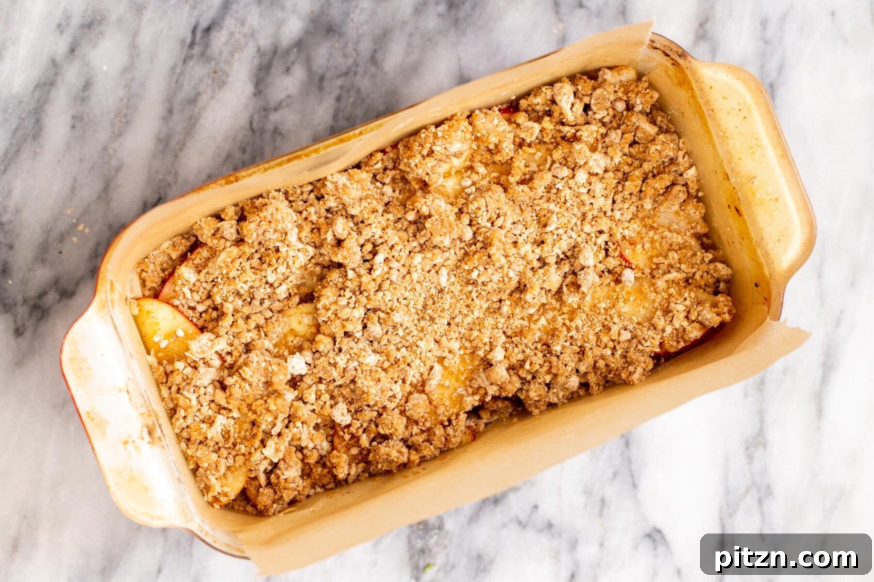 apple pie crumble bars in a baking pan 
