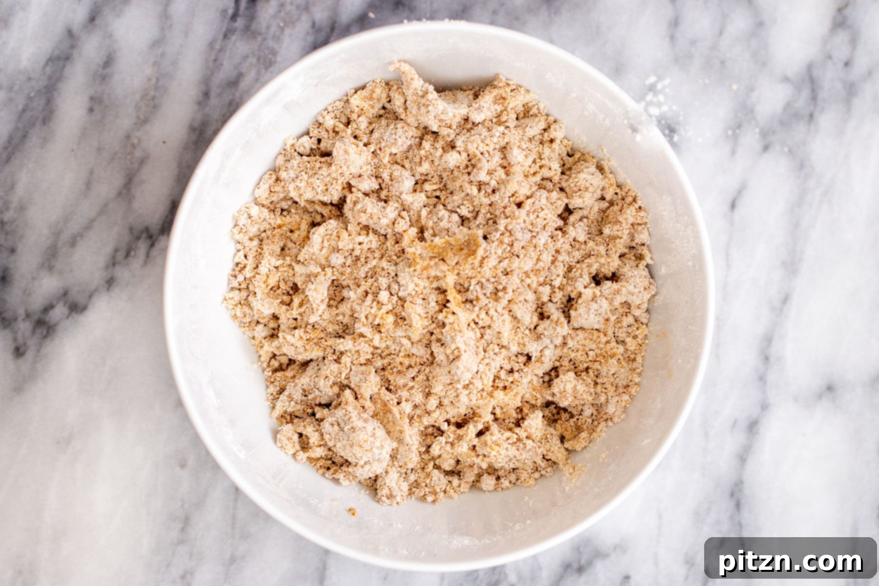 vegan apple pie bars crust in a white bowl 