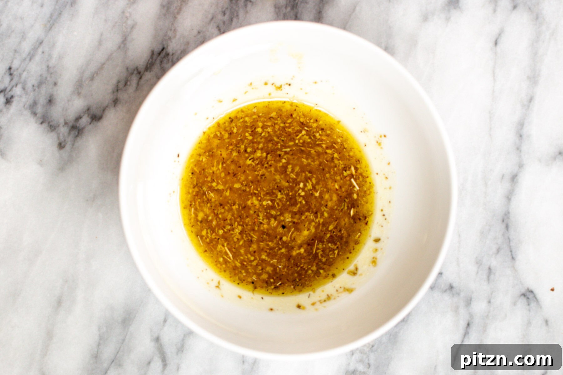 Mediterranean dressing in a small white dish