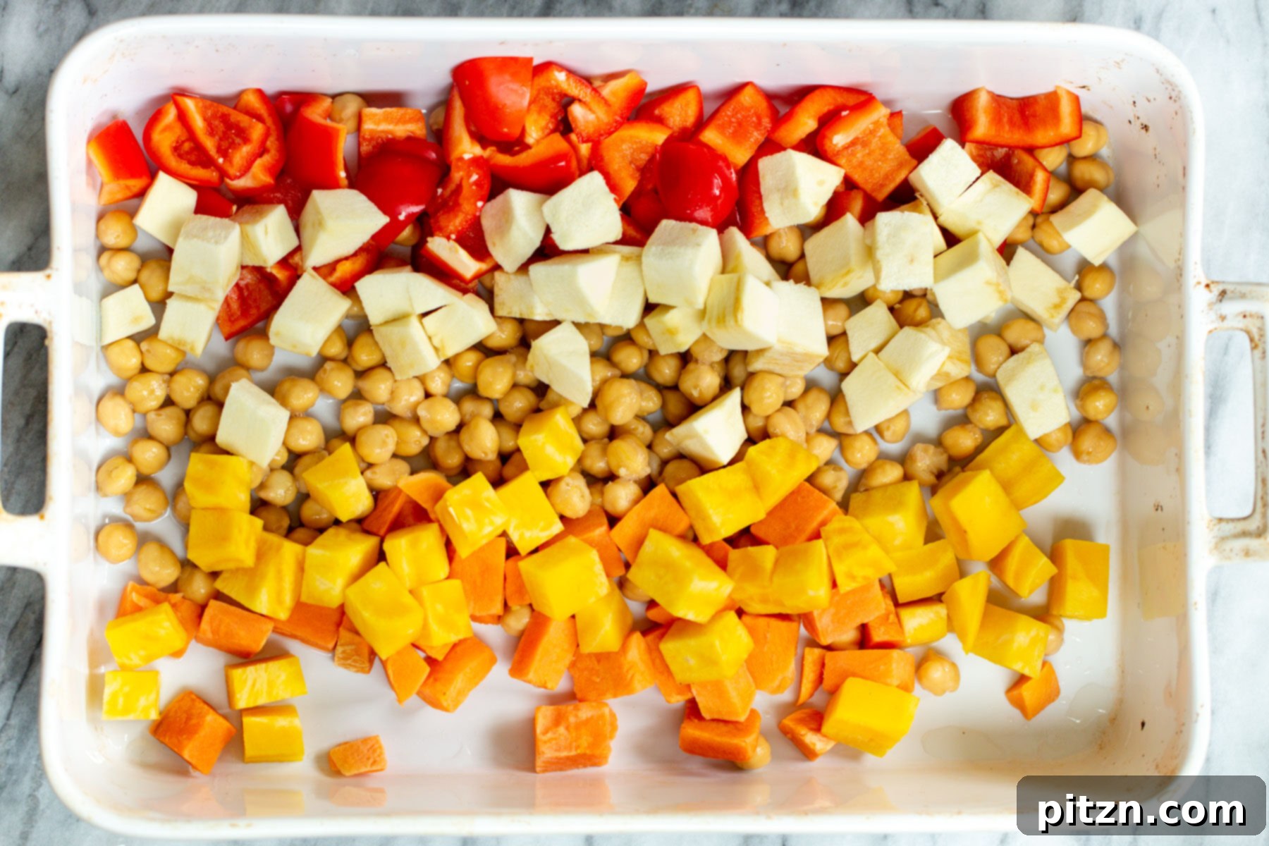butternut squash, chickpeas and parsnips in a white casserole dish