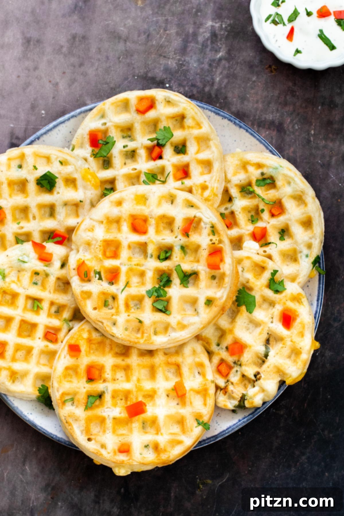 Kickin' Vegan Cheddar Jalapeno Waffles 2 a plate of small vegan cheddar jalapeno waffles on a plate