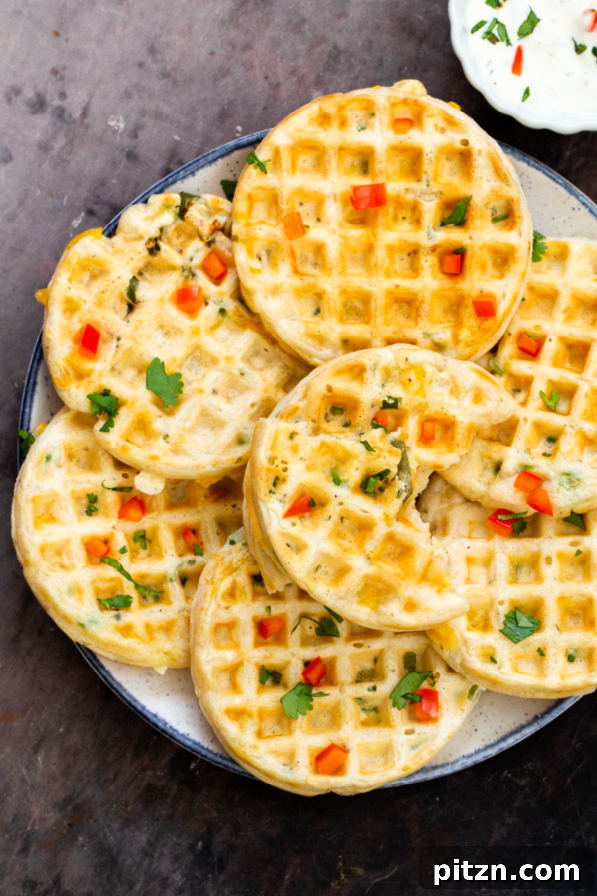 Kickin' Vegan Cheddar Jalapeno Waffles 11 a plate of vegan cheddar jalapeno waffles