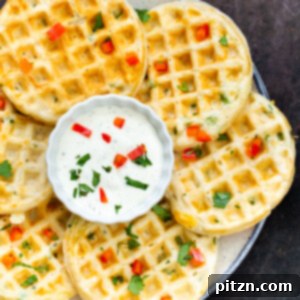 Kickin' Vegan Cheddar Jalapeno Waffles 5 A perfectly cooked vegan cheddar jalapeño waffle with a side of creamy dip, ready to be enjoyed.
