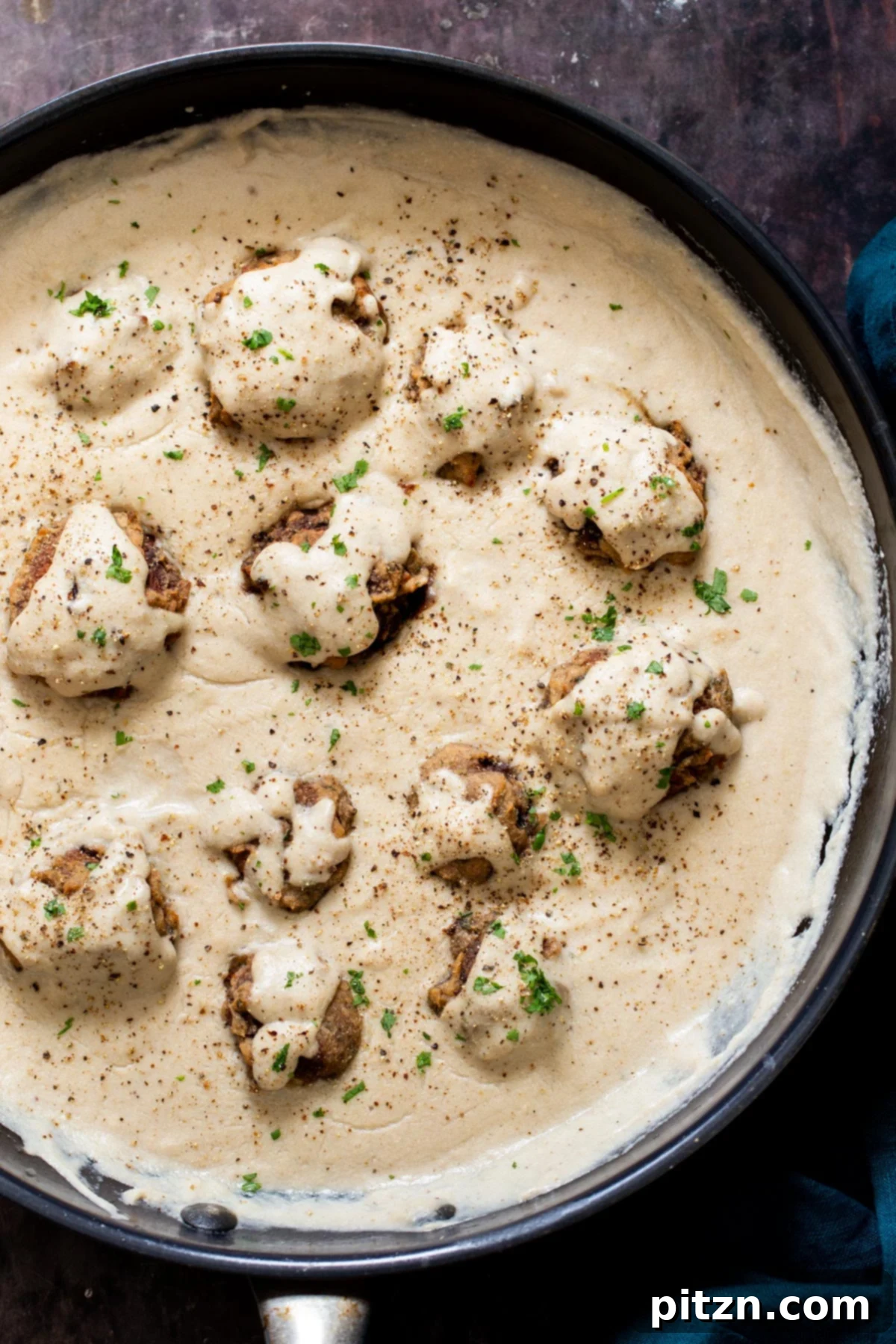 Swedish Plant-Ball Perfection 2 Tender vegan mushroom balls simmering in a creamy plant-based gravy, ready to serve.