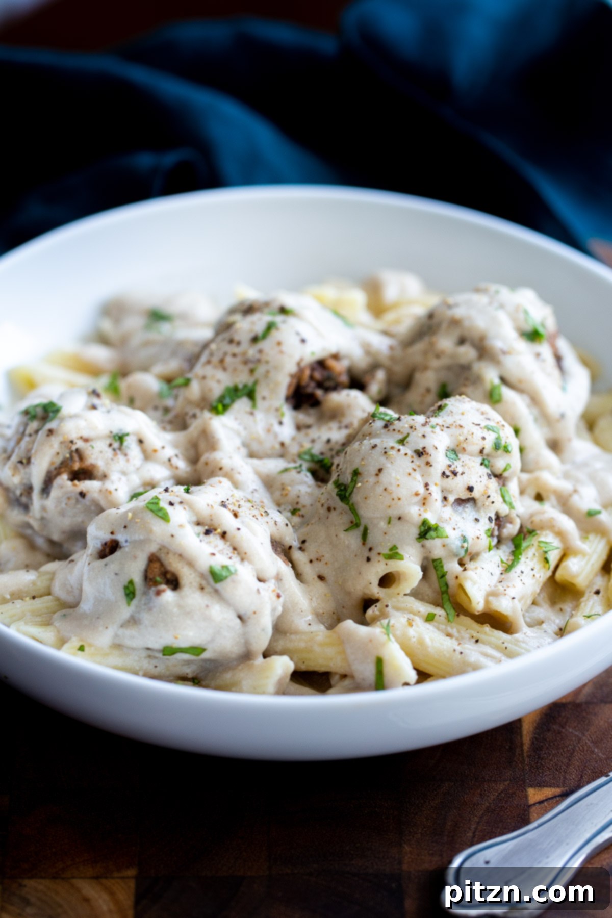 Swedish Plant-Ball Perfection 3 A beautifully plated dish of vegan Swedish mushroom meatballs served over a bed of pasta.