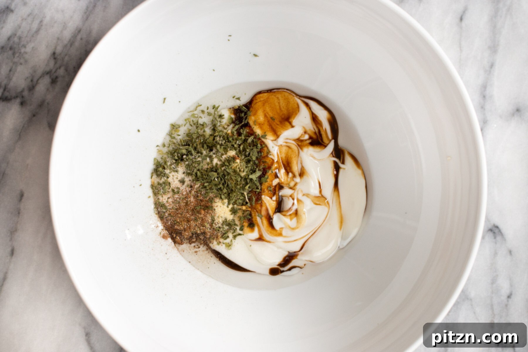 Swedish Plant-Ball Perfection 8 Vegan yogurt and seasonings being expertly mixed in a bowl to create the mushroom marinade.