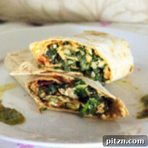 A cauliflower wrap cut in half and stacked, revealing the vibrant filling.