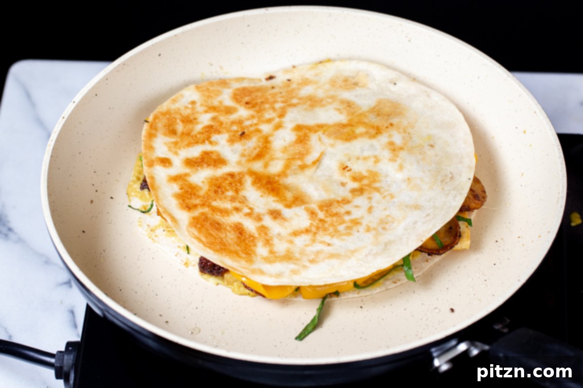 Smoky Tofu and Potato Sunrise Quesadillas 18 The vegan quesadilla being browned and crisped in a hot pan, ensuring a perfect texture.