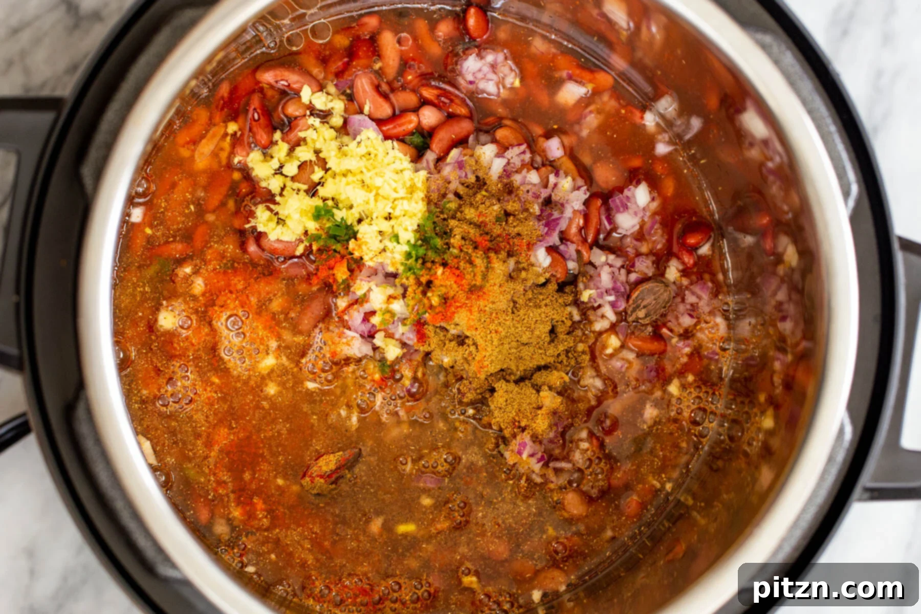 Instant Pot Dhaba Rajma: Authentic & Easy Kidney Bean Curry 9 Indian kidney bean curry mixture with ginger, garlic, and spices in an Instant Pot before pressure cooking