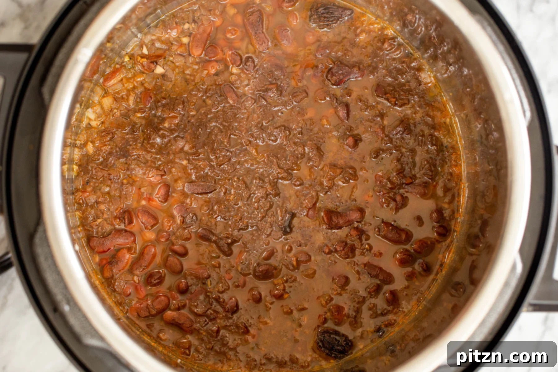 Instant Pot Dhaba Rajma: Authentic & Easy Kidney Bean Curry 11 cooked red kidney bean curry inside an Instant Pot, ready for the next steps