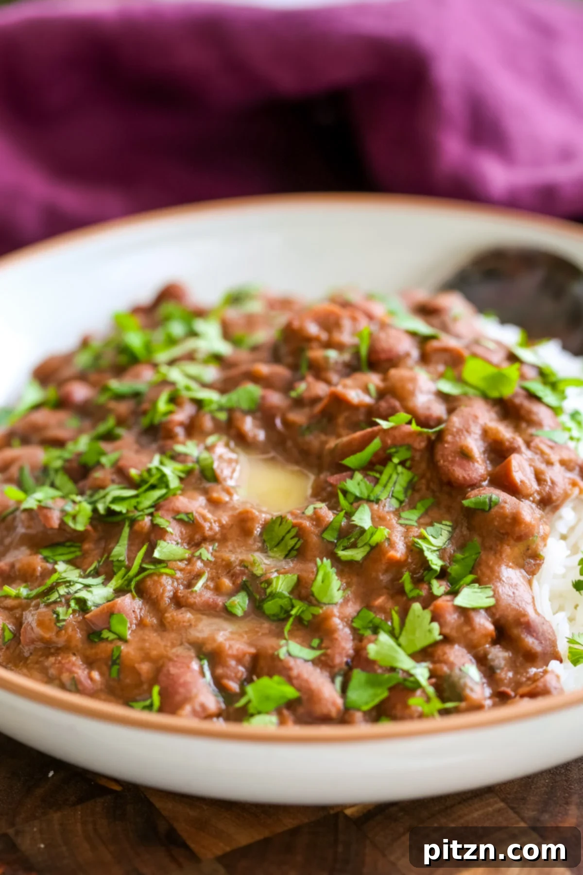 Instant Pot Dhaba Rajma: Authentic & Easy Kidney Bean Curry 3 a plate of Dhaba Style Rajma with rice, elegantly sprinkled with fresh cilantro