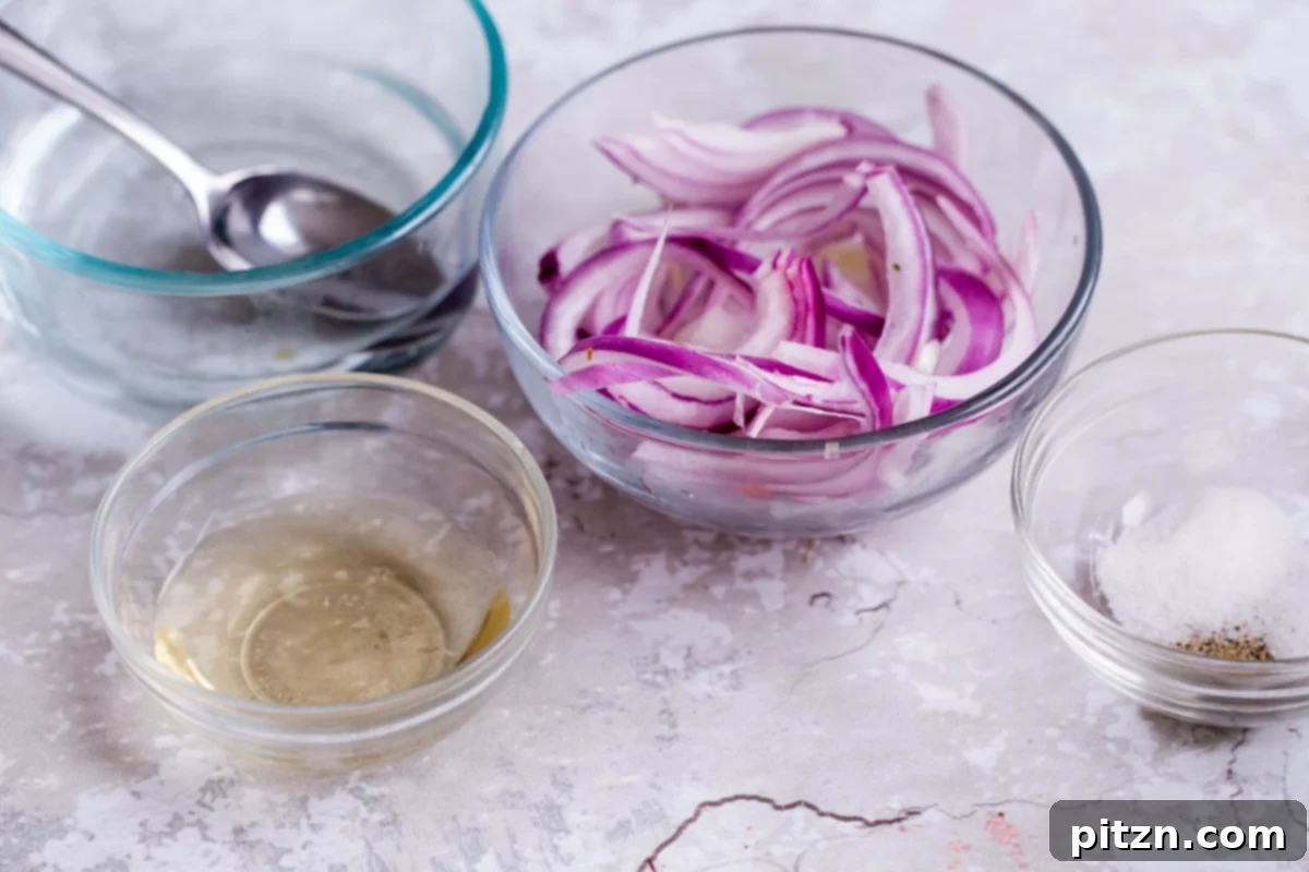 Ingredients laid out on a wooden surface to make quick pickled red onions, including sliced onions, vinegar, and spices