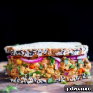 Top-down view of a curried chickpea salad sandwich, perfectly sliced and ready to eat