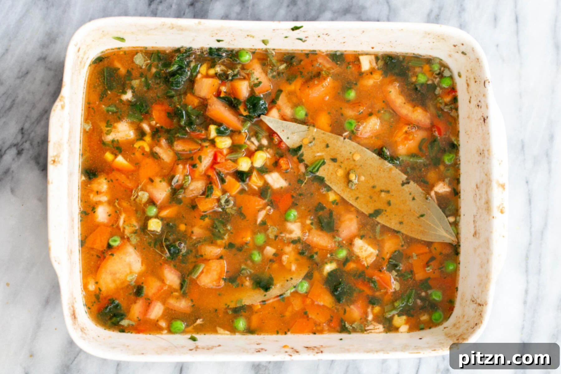 Spiced Kitchari Comfort Bake 13 A vegan Indian lentil rice casserole, perfectly assembled in a baking dish and securely covered, poised and ready to be placed in the oven for baking.