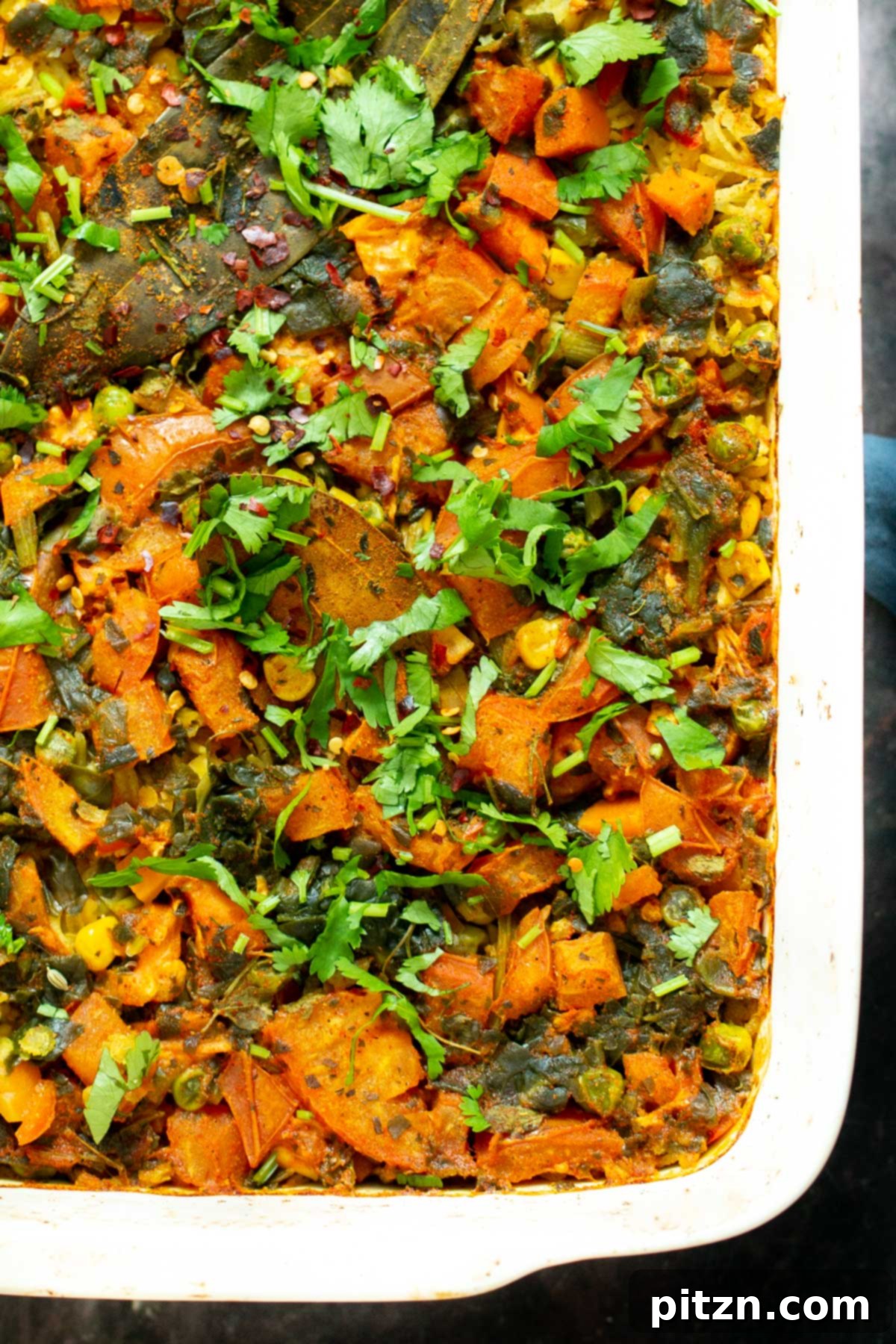 Spiced Kitchari Comfort Bake 14 A freshly baked vegan lentil rice casserole, beautifully garnished with vibrant fresh cilantro, signifying its readiness to be served and enjoyed.