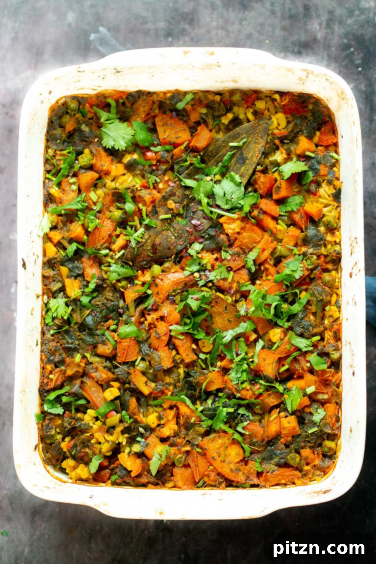 Spiced Kitchari Comfort Bake 3 A close-up shot of freshly baked lentil rice casserole, showcasing its golden-brown top and tender, flavorful grains.