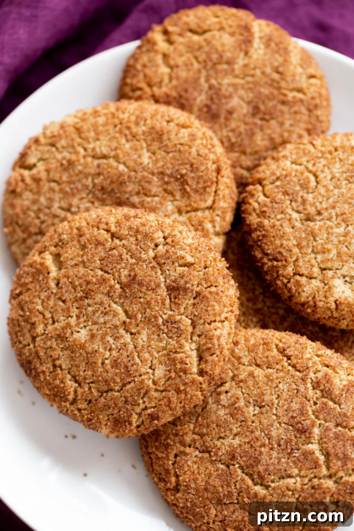 Soft and Chewy Gluten-Free Almond Flour Snickerdoodles 2 A beautifully arranged platter showcasing gluten-free vegan almond flour snickerdoodles, featuring their signature crinkly tops and golden-brown hue.