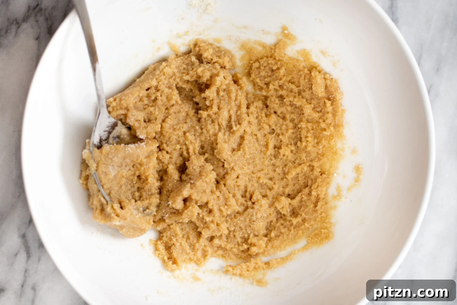 Soft and Chewy Gluten-Free Almond Flour Snickerdoodles 10 The perfectly chilled vegan snickerdoodles cookie dough resting in a white bowl, ready for shaping and baking.