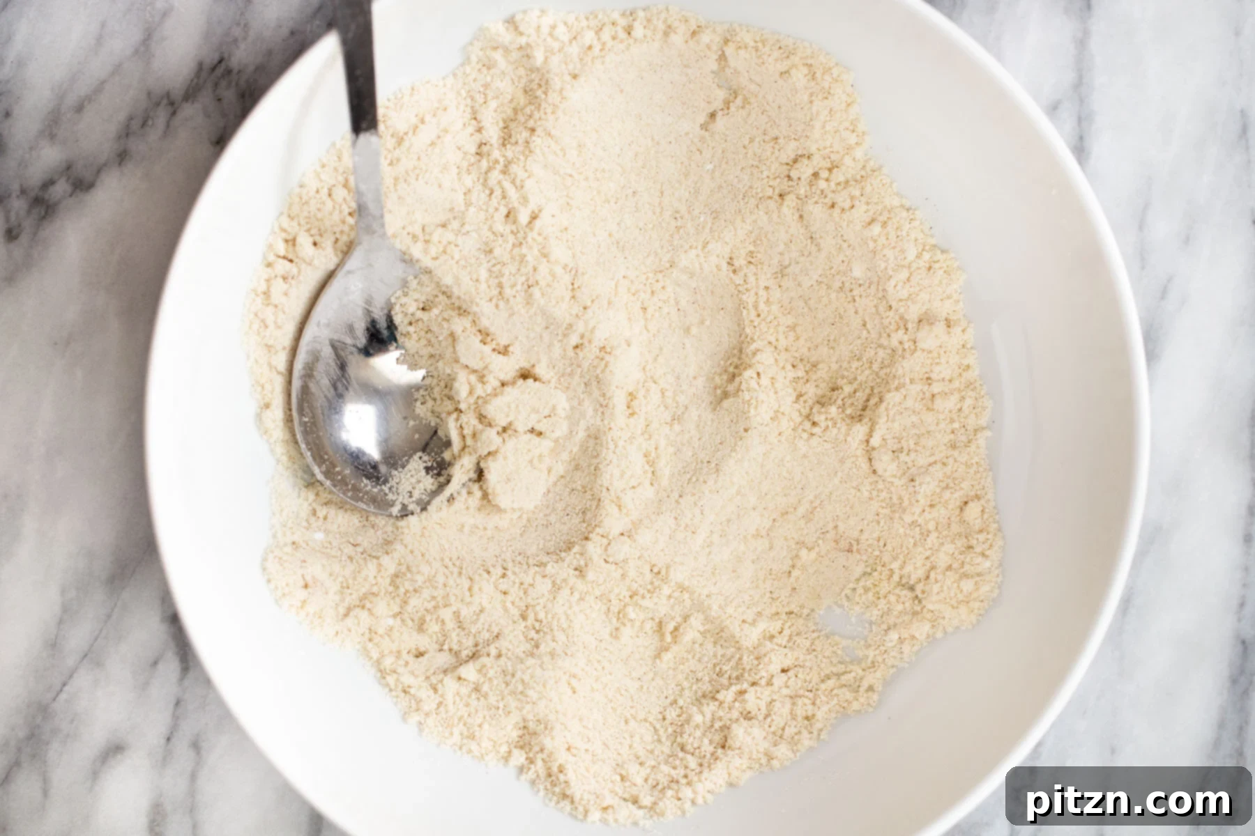 Soft and Chewy Gluten-Free Almond Flour Snickerdoodles 8 The well-mixed dry ingredients for the vegan snickerdoodle cookie batter, now perfectly combined in a bowl.