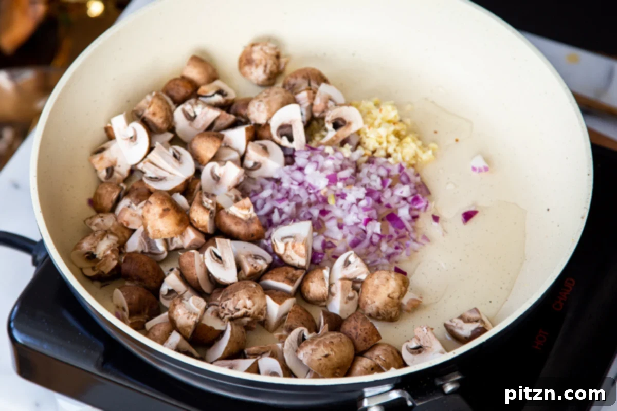 Creamy Vegan One-Pot Pasta: Mushrooms & Sun-Dried Tomatoes 9 Garlic, onion, and sliced mushrooms actively sautéing in a pan, beginning to brown and soften.