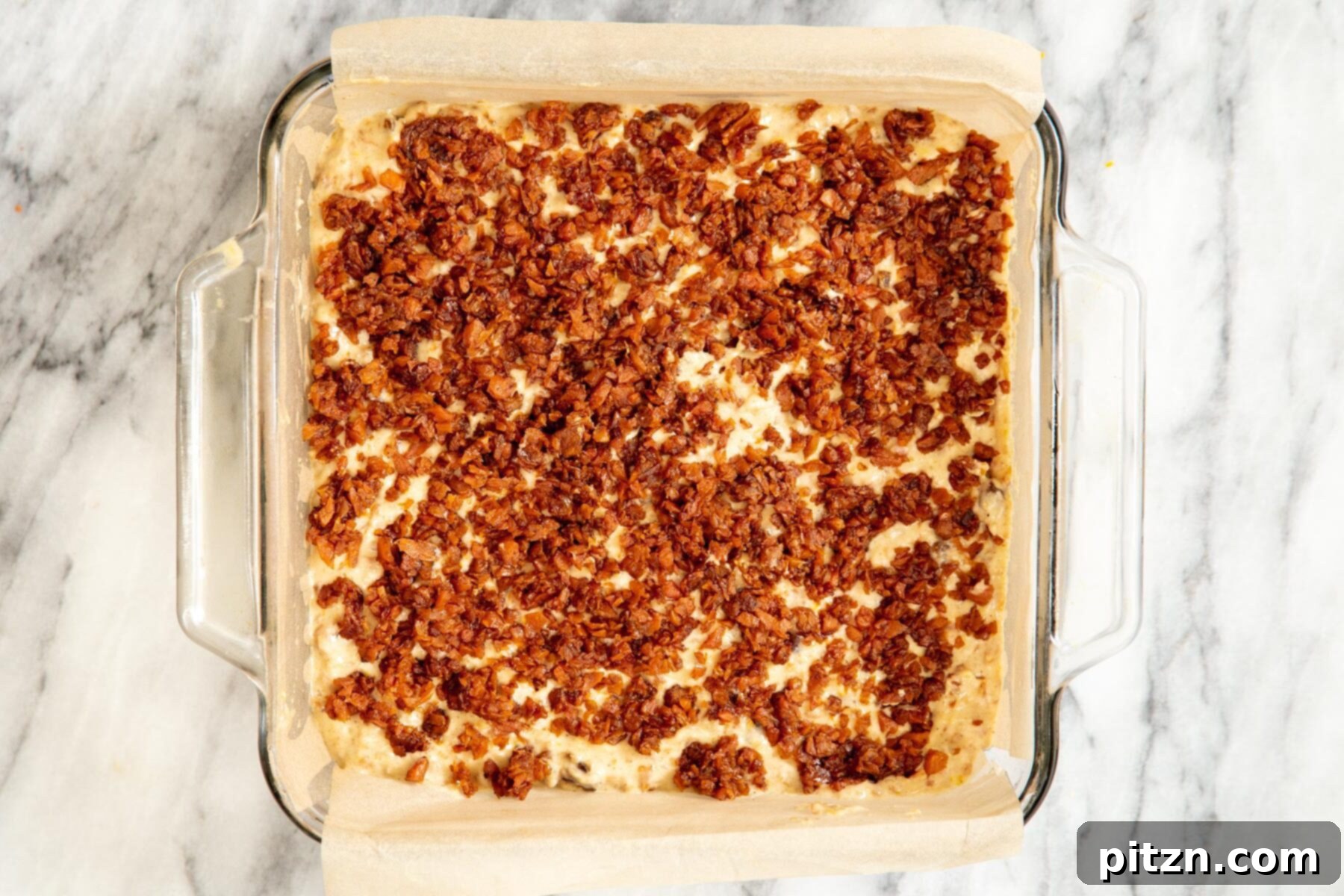 Spiced Vegan Carrot Cake Squares 20 Vegan carrot cake bars being topped with cinnamon brown sugar streusel before baking