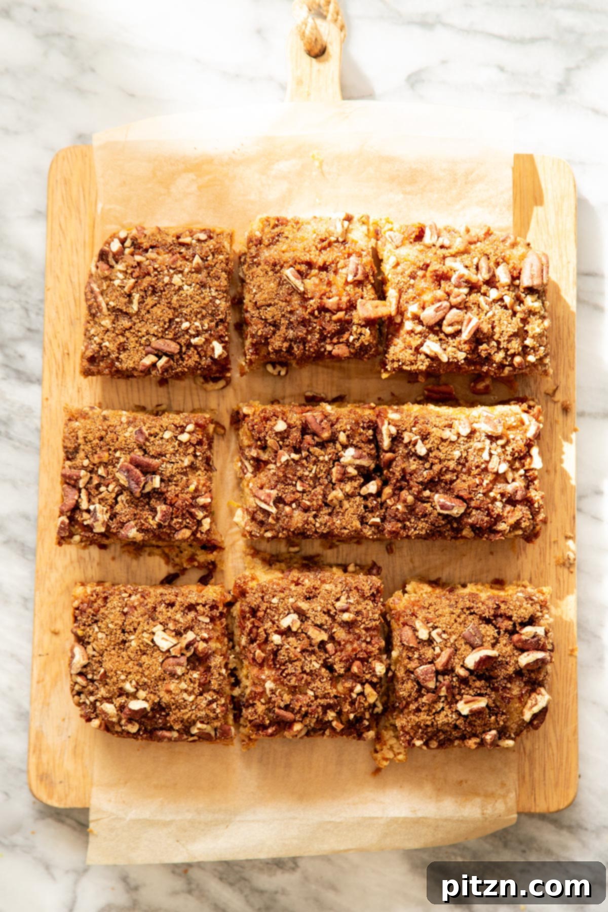 Spiced Vegan Carrot Cake Squares 24 Overhead shot of vegan carrot cake bars on a piece of parchment paper