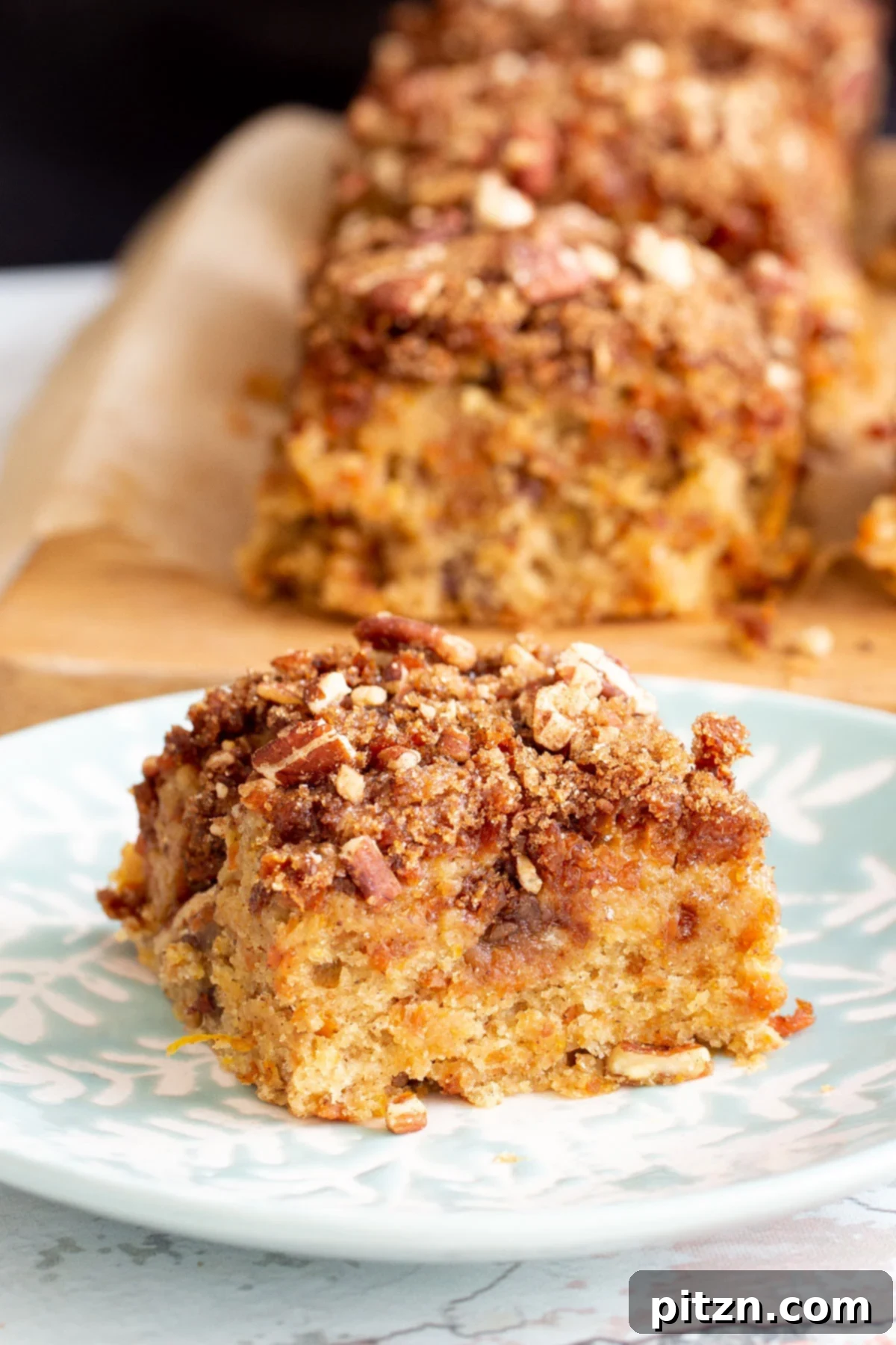 Spiced Vegan Carrot Cake Squares 4 A piece of vegan carrot cake with caramelized carrots on a cake plate