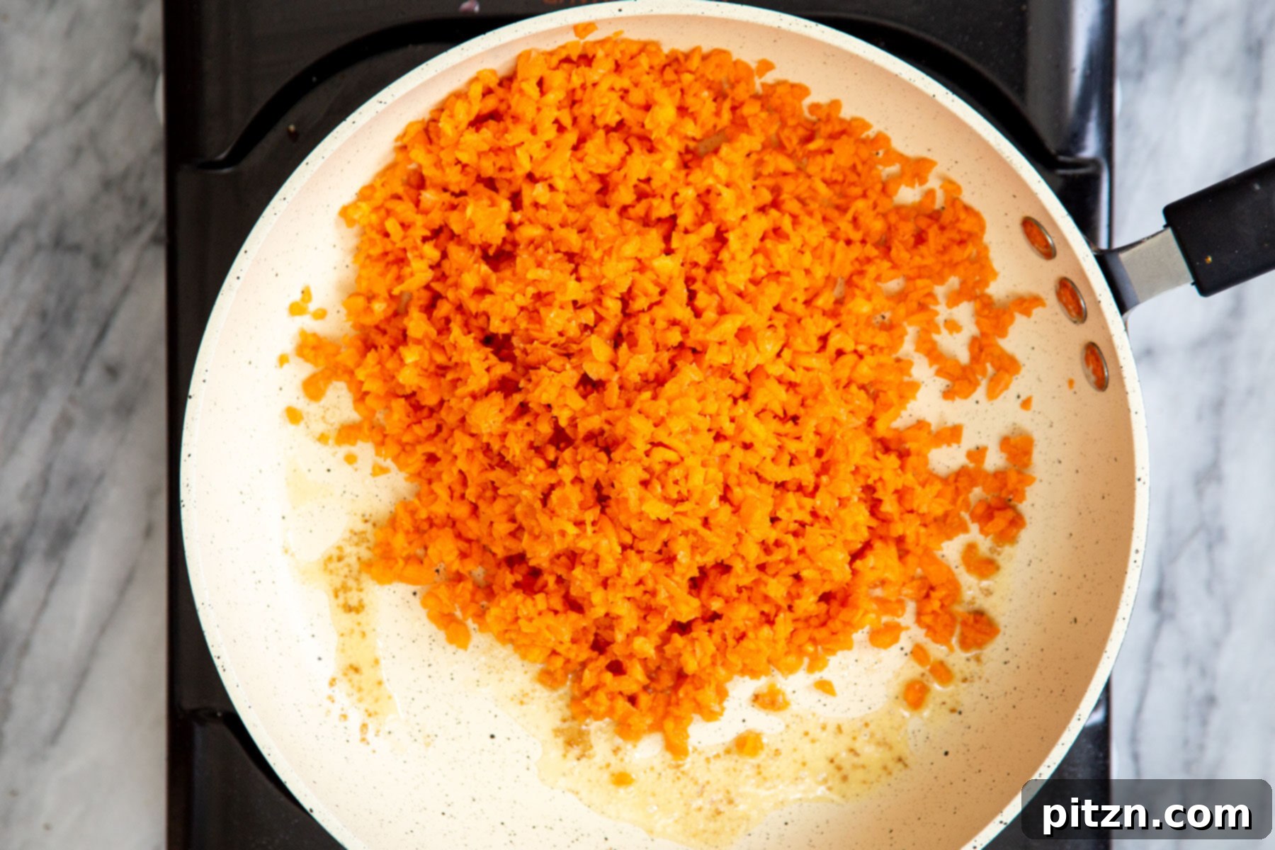 Spiced Vegan Carrot Cake Squares 7 Shredded carrots in a sautéing pan