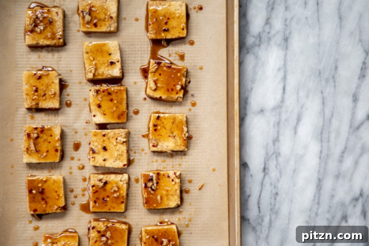 marinated tofu cubes on a sheetpan ready for baking