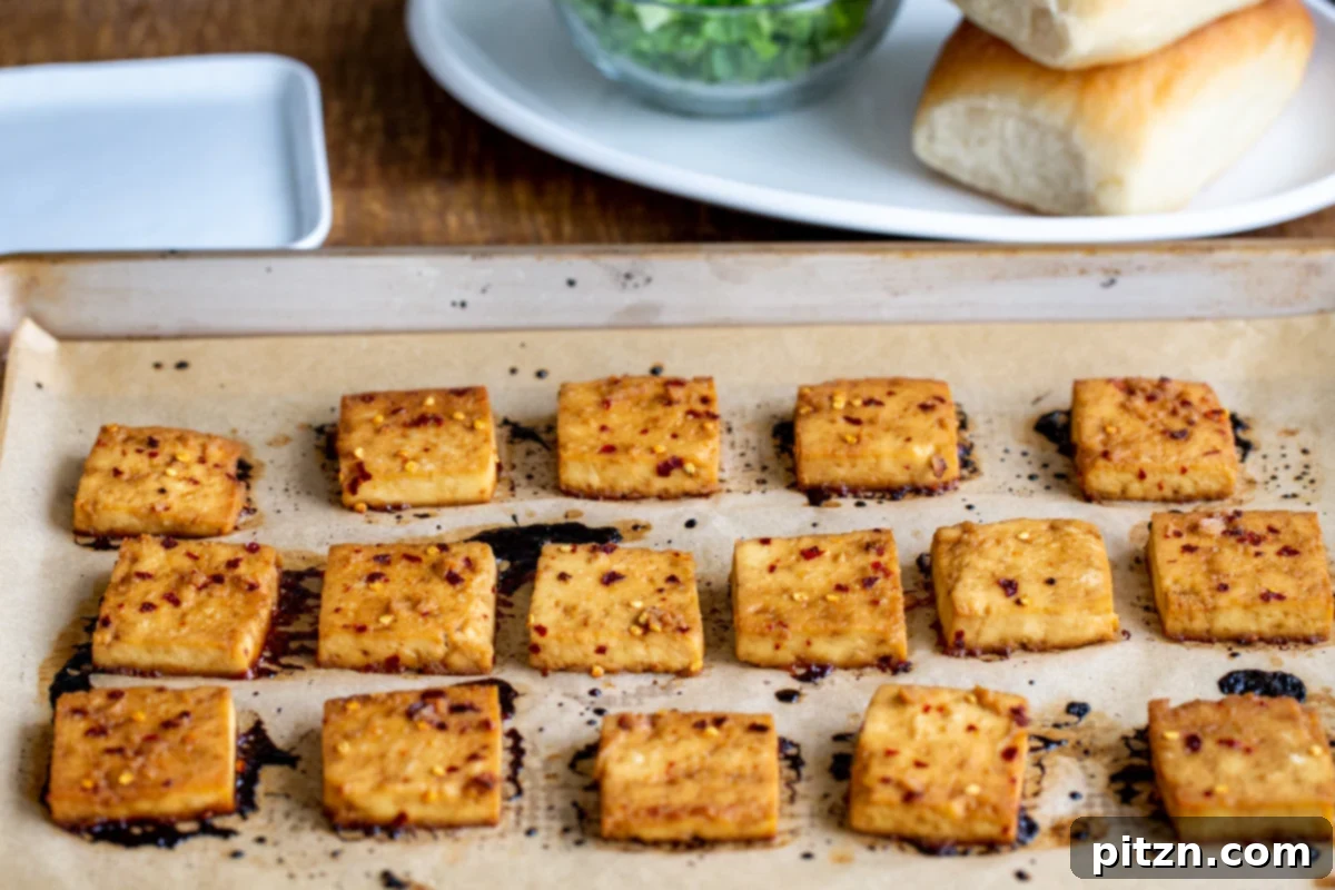 baked marinated chili garlic tofu on a sheetpan