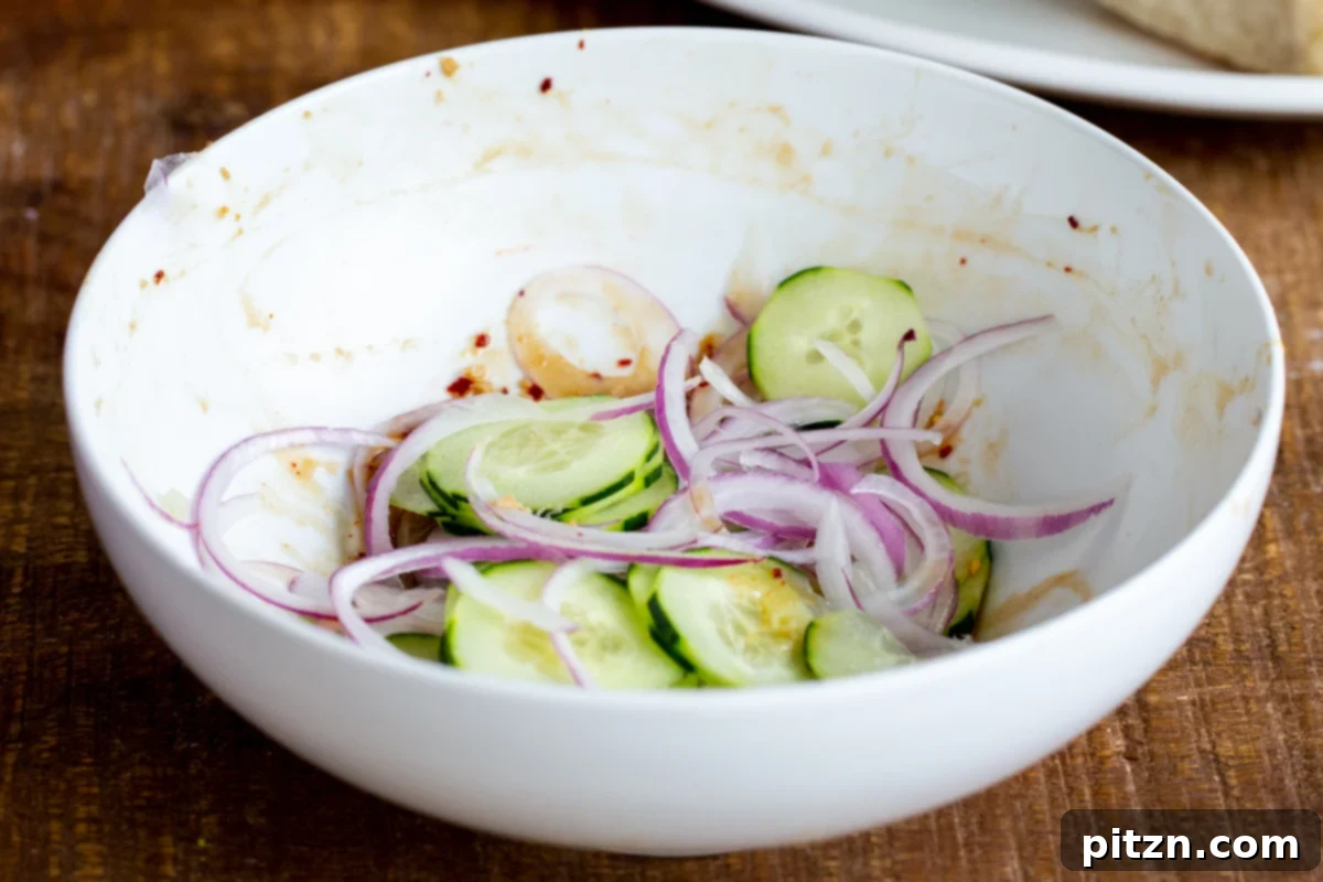 cucumber and onion slices in a small bowl
