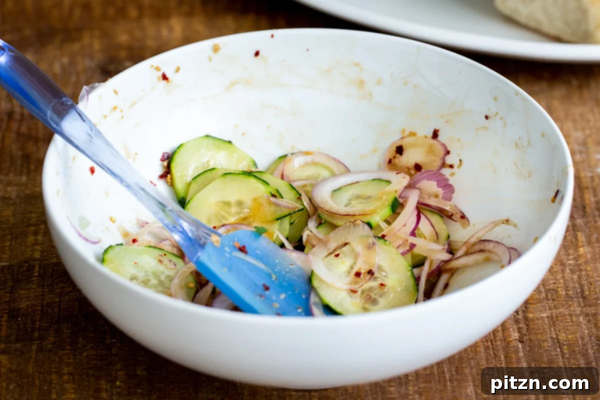 marinated cucumber and onion slices in a small bowl