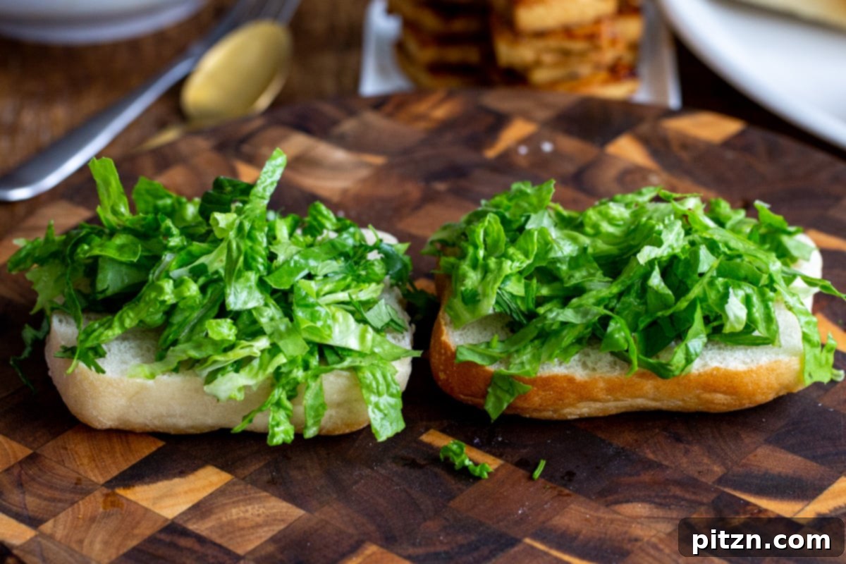 two bread halves topped with chopped lettuce