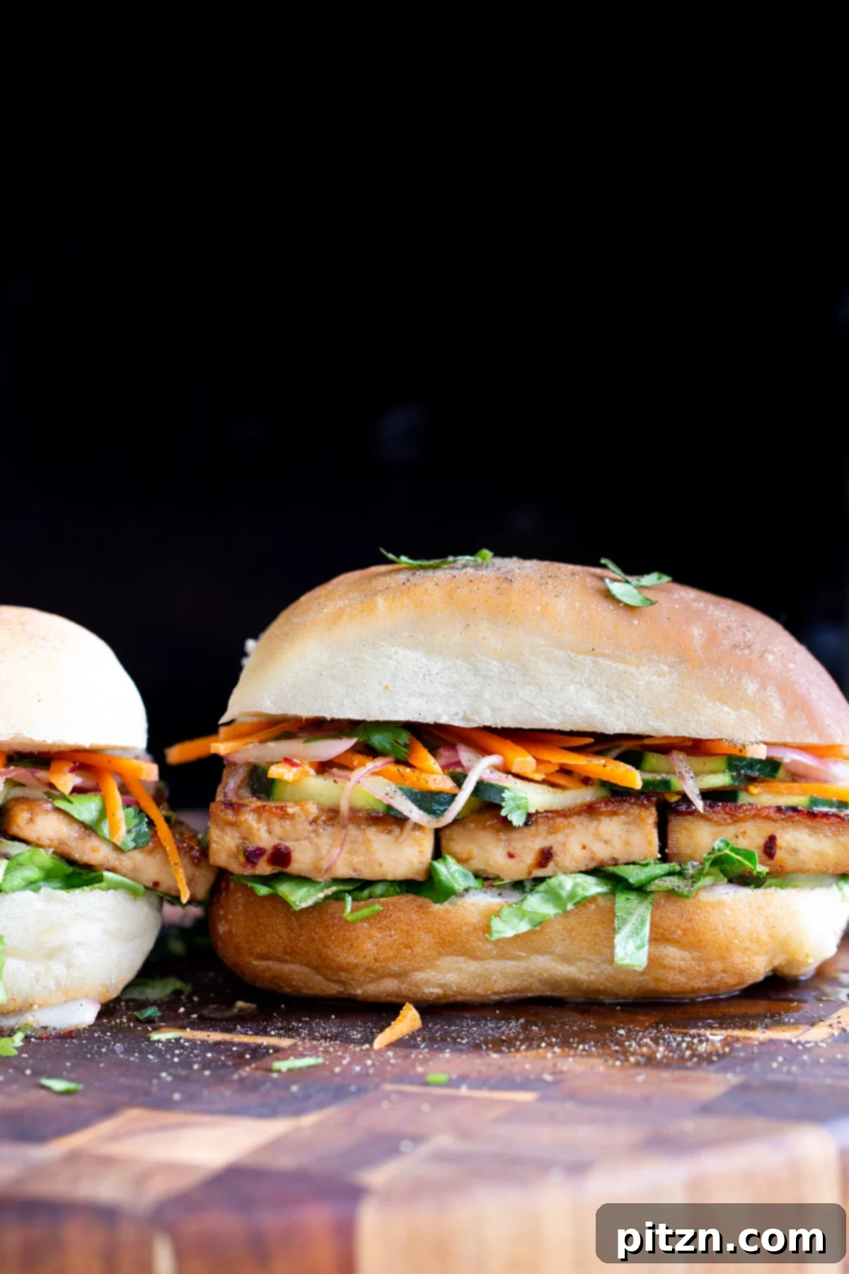 side view of a vegan chili garlic tofu sandwich on a chopping board