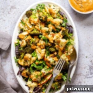Roasted Broccoli Cauliflower Salad with Sun dried Tomato Dressing on white serving platter