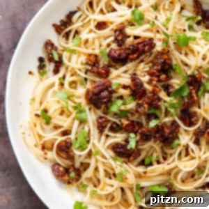 Finished plate of vegan chili garlic oil pasta with smoky pecans