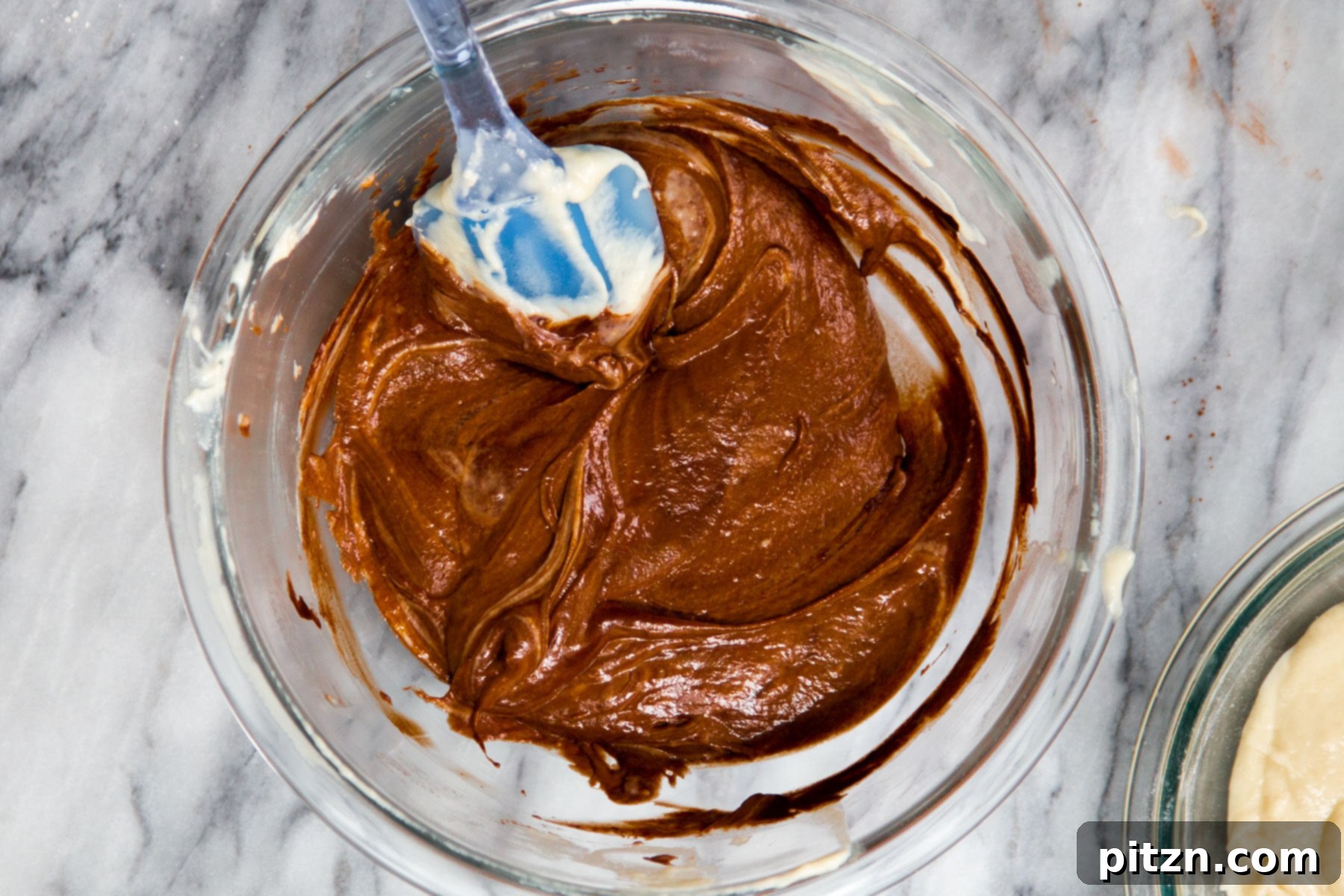 Decadent Mocha Swirl Cake 14 A bowl of glossy, dark mocha cake batter, now fully mixed and ready to be combined with the vanilla batter.