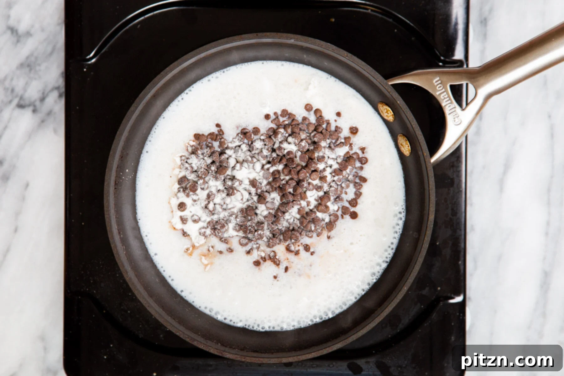Decadent Mocha Swirl Cake 20 Vegan semi-sweet chocolate chips being added to hot coconut milk in a saucepan.