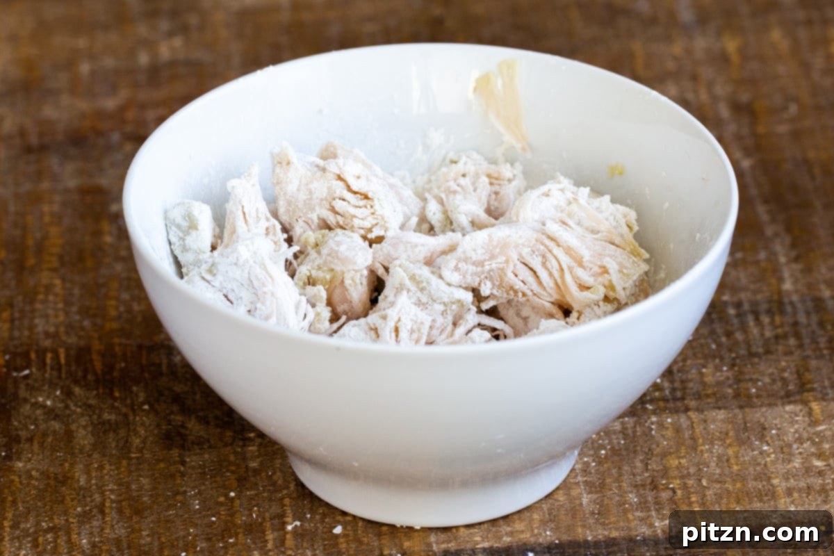 jackfruit tossed with cornstarch in a small white bowl 