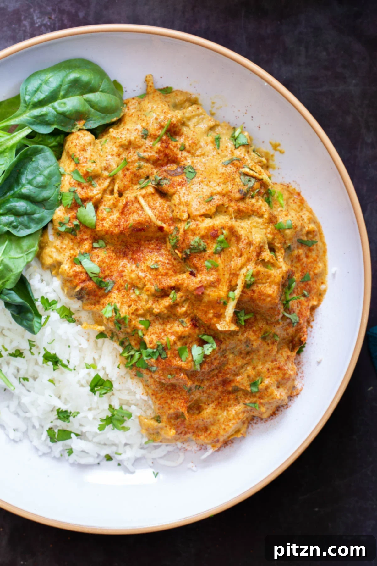 vegan jackfruit korma served with rice and spinach 
