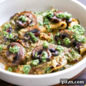 A close-up of a serving of vegan skillet pesto lasagna, ready to be enjoyed.