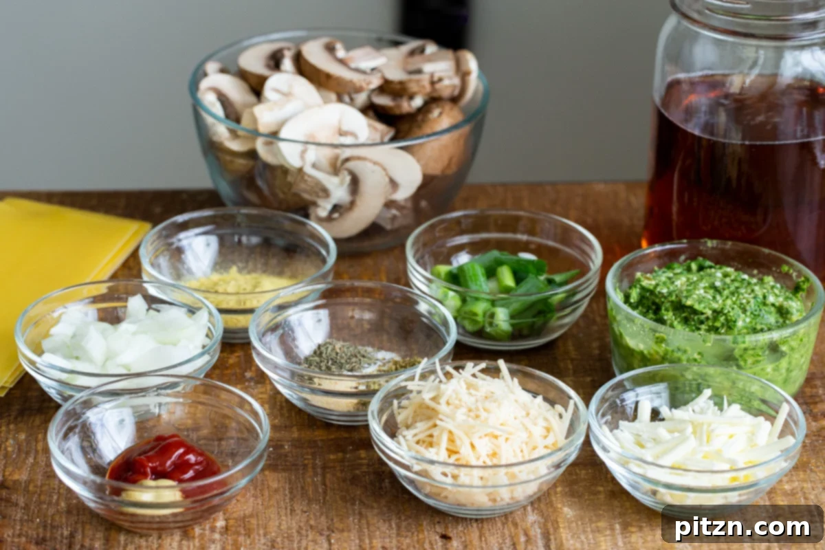 A collection of fresh ingredients laid out on a marble countertop, ready for making vegan pesto skillet lasagna.