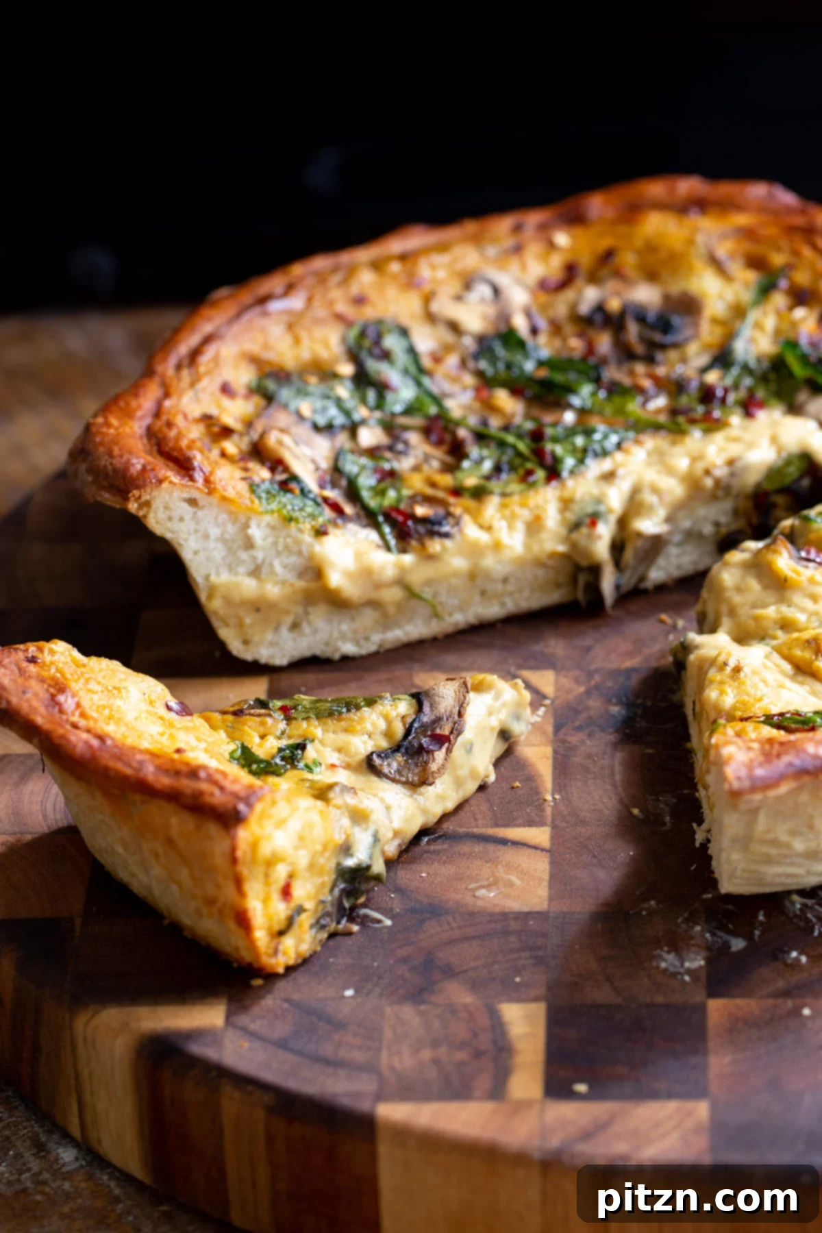 Deep Dish Pizza with a Pretzel Twist 2 A delectable vegan deep dish pizza with a golden pretzel crust, one slice being carefully cut from the pan, revealing its rich, cheesy interior, served on a rustic wooden board.