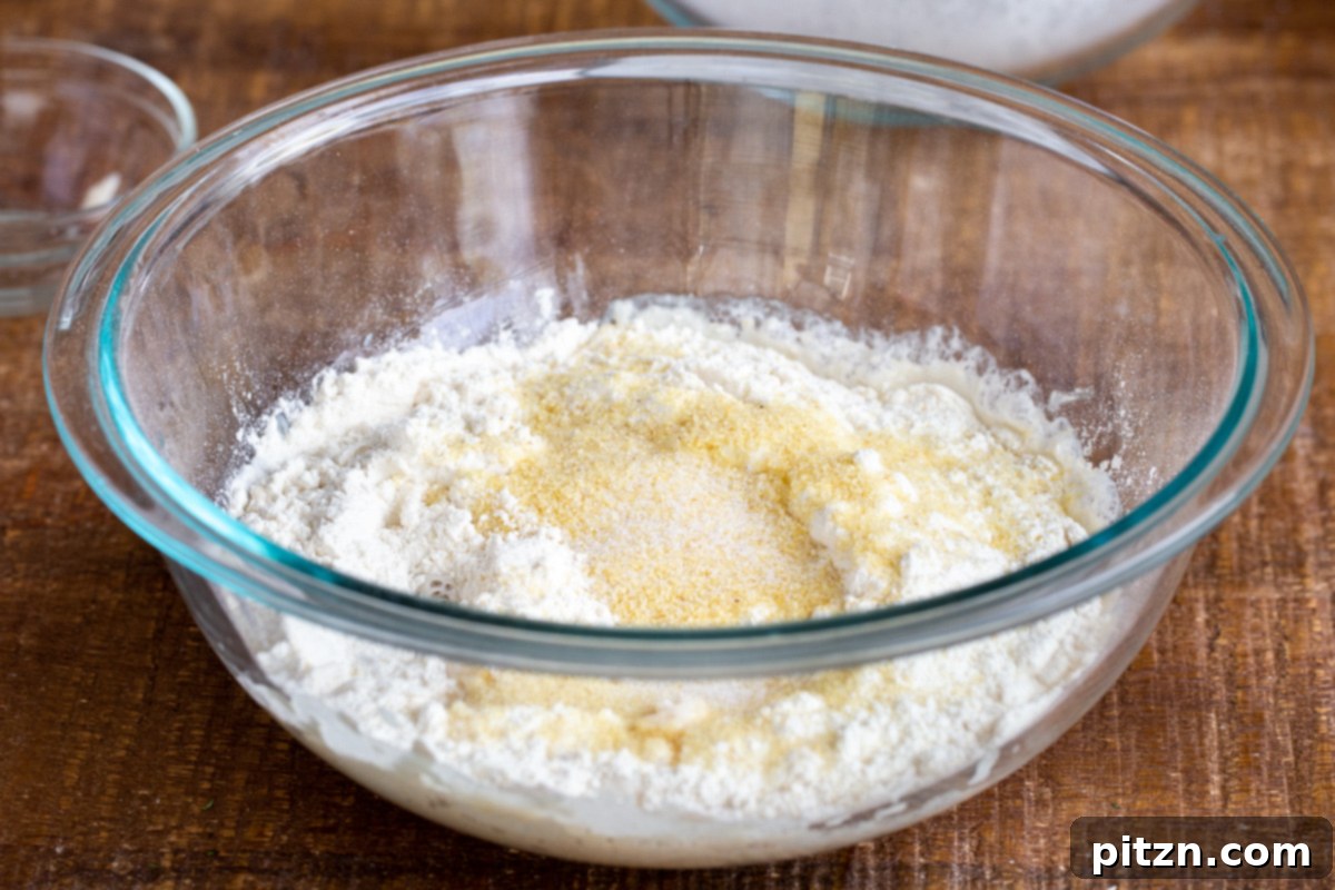 Deep Dish Pizza with a Pretzel Twist 10 A large mixing bowl filled with dry ingredients for the pretzel crust pizza dough, including all-purpose and semolina flours, ready to be combined with the wet mixture.