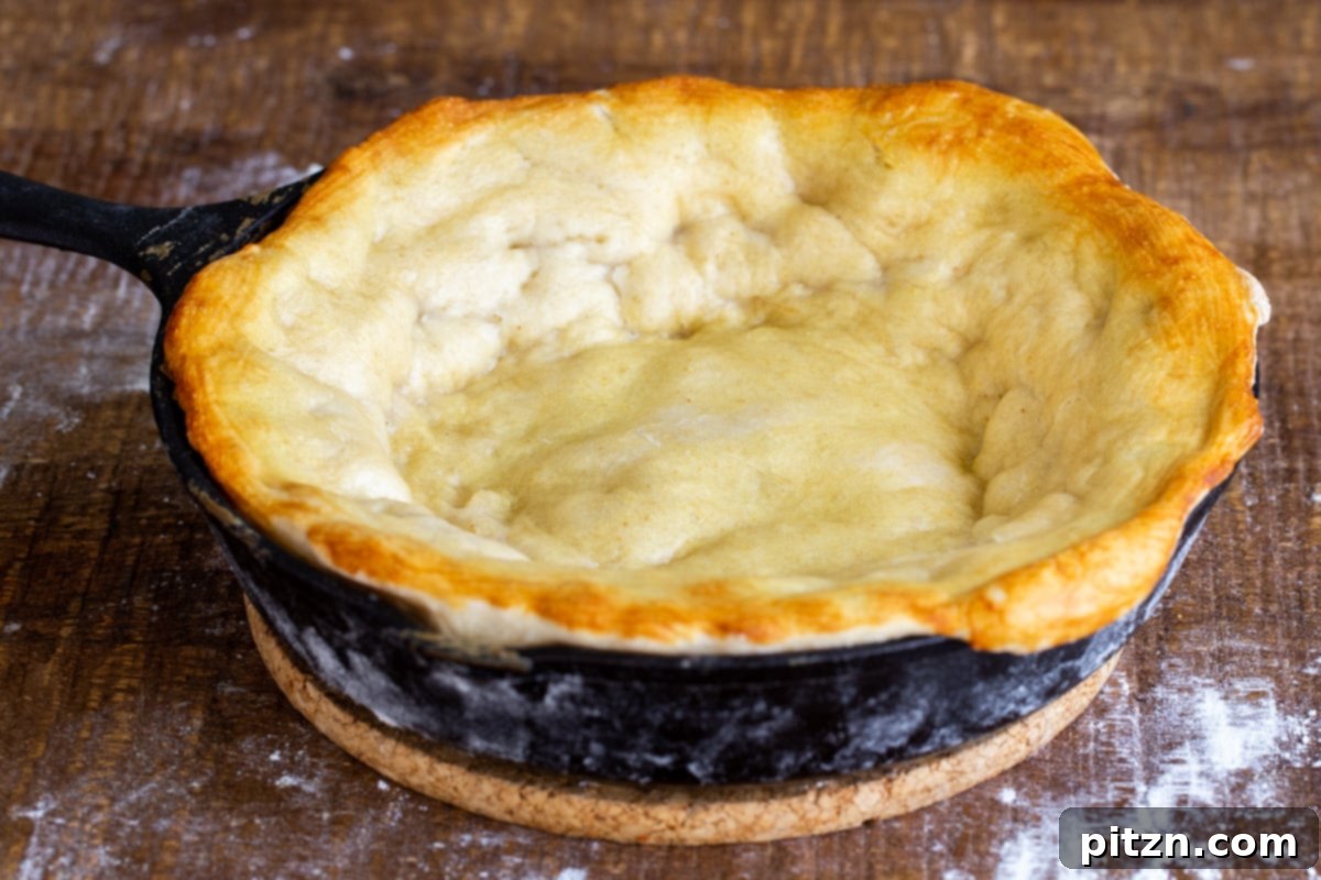 Deep Dish Pizza with a Pretzel Twist 13 A beautifully prebaked pretzel crust sitting in a black cast iron skillet, its edges already showing a golden-brown hue from the initial bake.