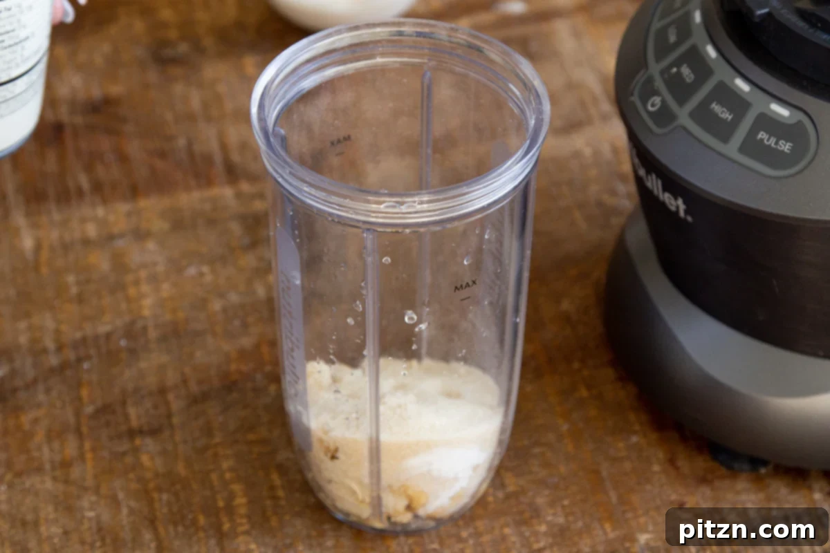 Plant-Based Tiramisu Tray Bake 15 Ingredients for vegan cashew mascarpone cream gathered in a Nutribullet blender, ready to be processed into a smooth, creamy texture.