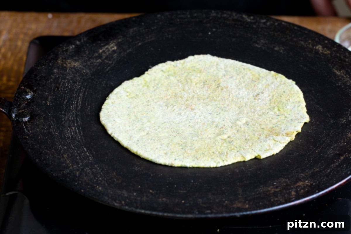 Aromatic Masala Paratha: Easy Yeast-Free Indian Flatbread 11 a masala paratha being toasted in a flat skillet