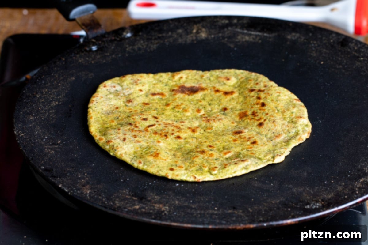 Aromatic Masala Paratha: Easy Yeast-Free Indian Flatbread 13 freshly toasted masala paratha in a black flat skillet